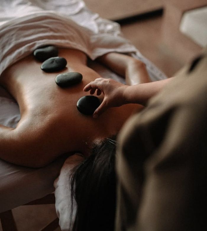 Warm basalt stones placed along a client's back during a hot stone massage